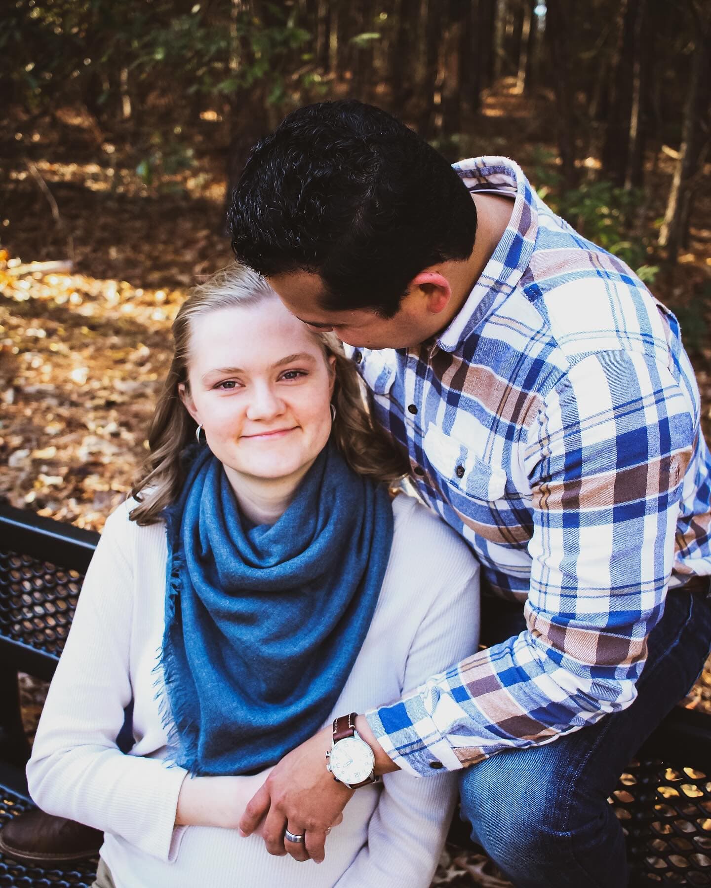 An expecting couple standing quietly together